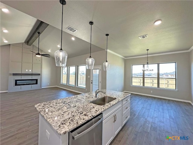 kitchen featuring white cabinetry, sink, stainless steel dishwasher, pendant lighting, and ceiling fan with notable chandelier