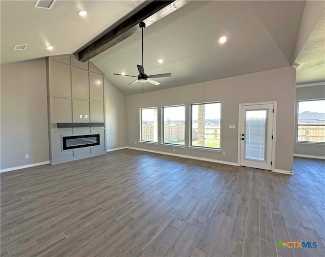 unfurnished living room with vaulted ceiling with beams, ceiling fan, a large fireplace, and wood-type flooring