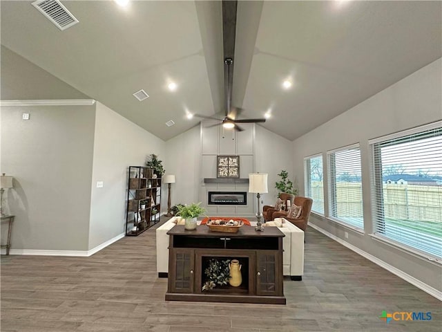 living room with vaulted ceiling with beams, ceiling fan, and wood-type flooring