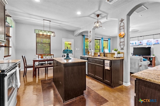 kitchen featuring a kitchen island, hanging light fixtures, a textured ceiling, and stainless steel range with electric cooktop