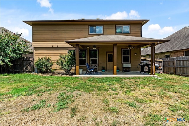 back of property featuring a patio area, ceiling fan, and a yard