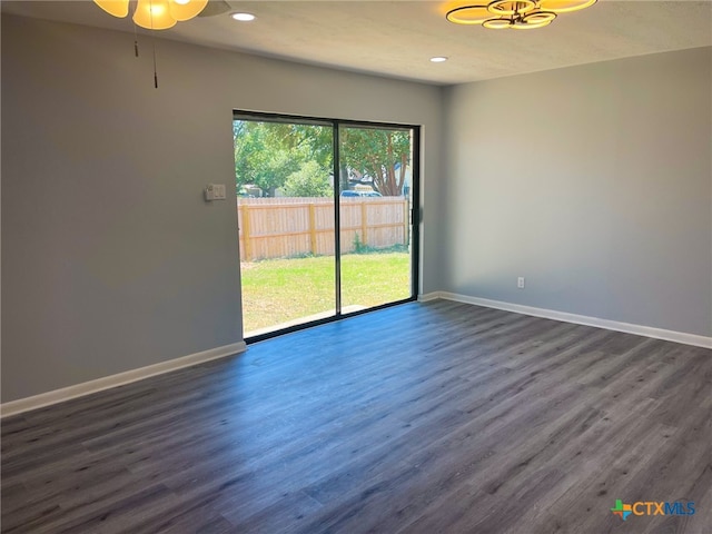 empty room with a textured ceiling, dark hardwood / wood-style floors, and ceiling fan