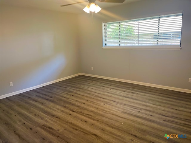 unfurnished room with dark hardwood / wood-style flooring and ceiling fan