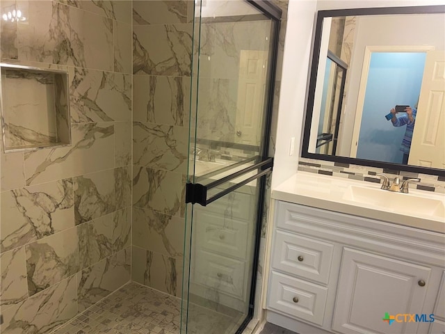 bathroom with walk in shower and vanity