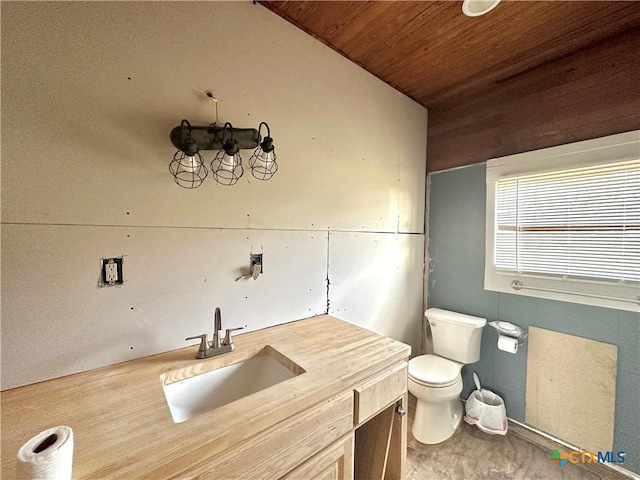 bathroom featuring vanity, toilet, and wooden ceiling