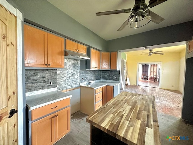 kitchen with ceiling fan, wood-type flooring, butcher block counters, and backsplash