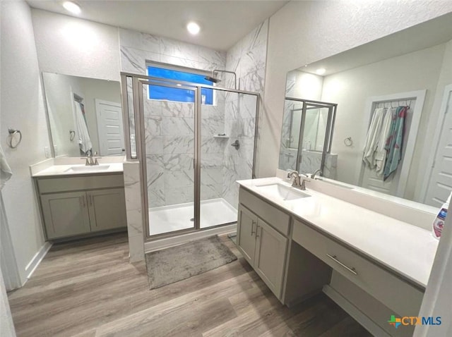 bathroom featuring hardwood / wood-style flooring, an enclosed shower, and vanity