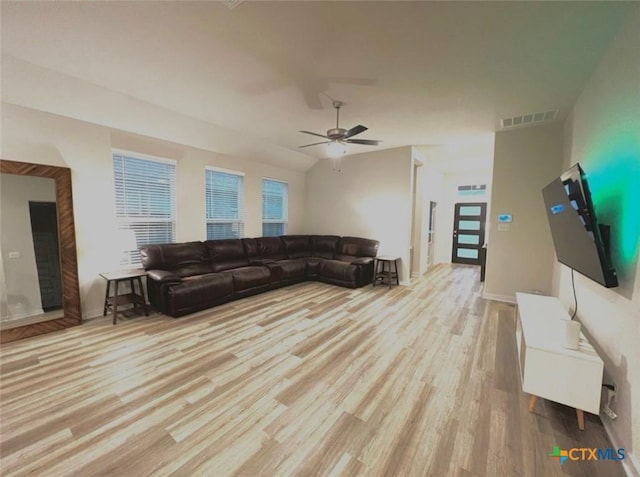 living room featuring lofted ceiling, ceiling fan, and light hardwood / wood-style flooring