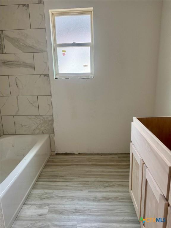 full bathroom featuring wood finished floors