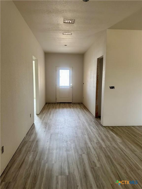 spare room featuring wood finished floors