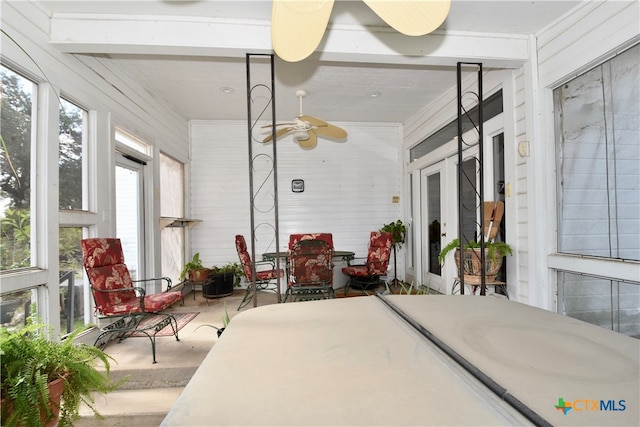 sunroom / solarium featuring ceiling fan