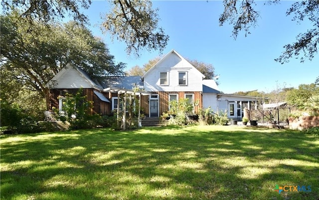 rear view of house with a lawn