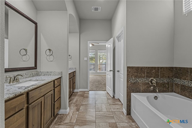 bathroom with a bathtub and vanity