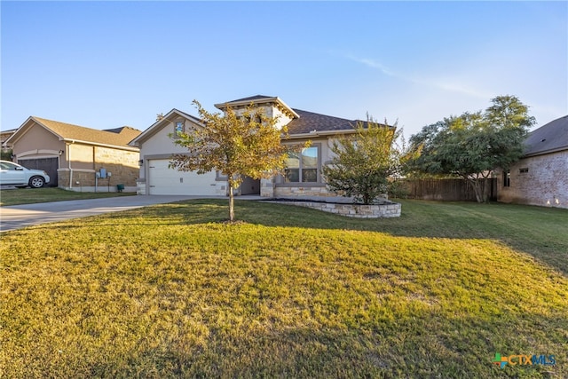 view of front of property featuring a garage and a front yard