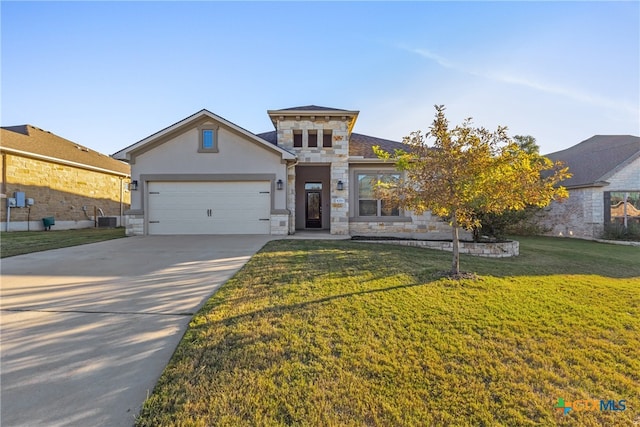 view of front of house featuring central AC unit, a garage, and a front yard