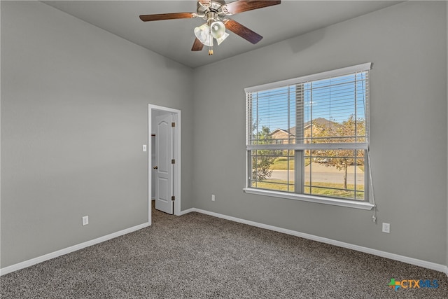 carpeted spare room with ceiling fan