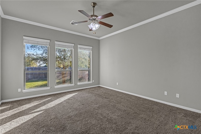 carpeted spare room with ceiling fan and crown molding