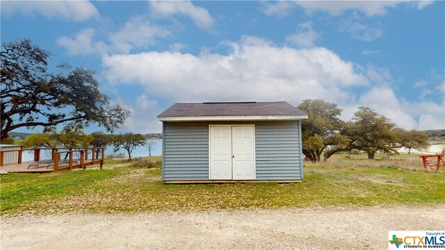 view of outdoor structure featuring a lawn