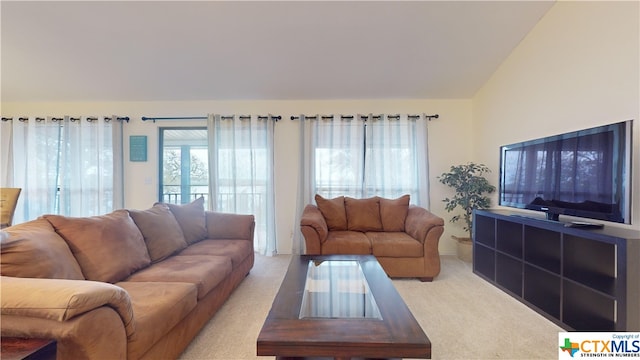 carpeted living room featuring lofted ceiling