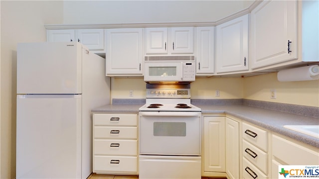 kitchen featuring white appliances and white cabinetry