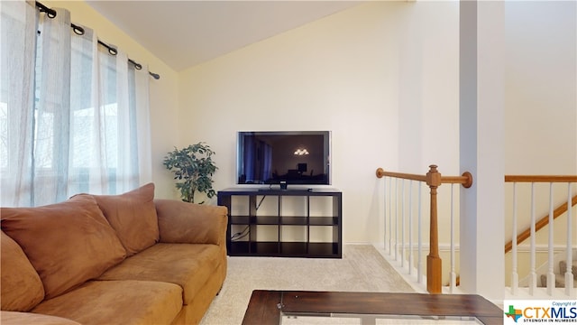 living room with lofted ceiling and carpet