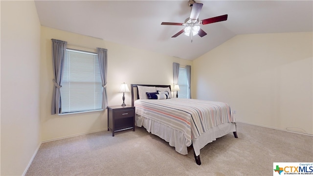 bedroom featuring ceiling fan, vaulted ceiling, and light carpet