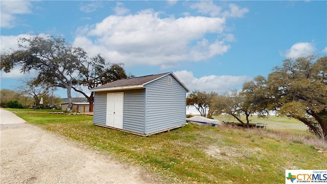 view of outbuilding with a lawn