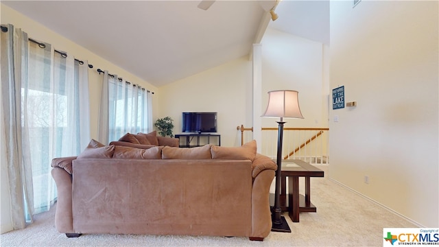 carpeted living room featuring vaulted ceiling