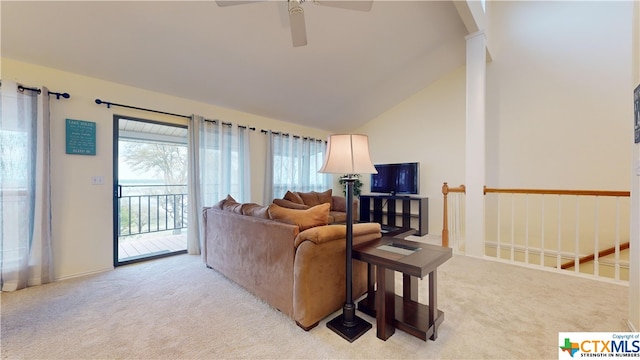 living room with ceiling fan, high vaulted ceiling, and light carpet