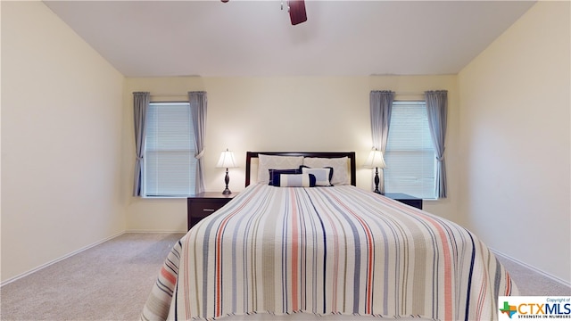 bedroom with ceiling fan and light colored carpet