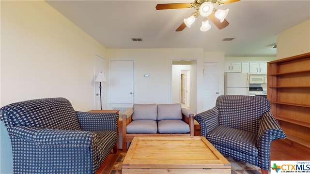 living room with ceiling fan and dark hardwood / wood-style flooring