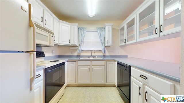 kitchen with white cabinetry, sink, and white appliances