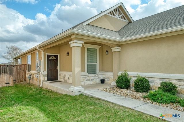 doorway to property with a lawn