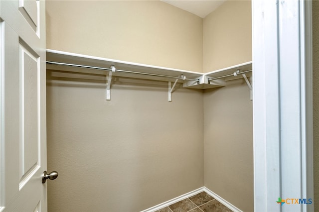 spacious closet featuring tile patterned flooring