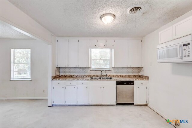907 Curry Ave, Copperas Cove, TX 76522 - kitchen with dishwasher, white microwave, a sink, white cabinets, and a textured ceiling