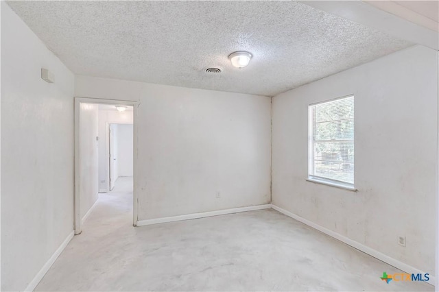 907 Curry Ave, Copperas Cove, TX 76522 - spare room with a textured ceiling, baseboards, and concrete floors