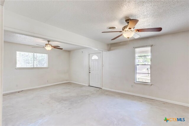 907 Curry Ave, Copperas Cove, TX 76522 - empty room featuring a textured ceiling, a ceiling fan, unfinished concrete flooring, and baseboards