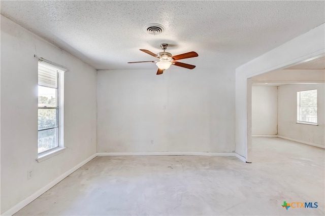 907 Curry Ave, Copperas Cove, TX 76522 - spare room featuring unfinished concrete flooring, ceiling fan, a textured ceiling, and baseboards