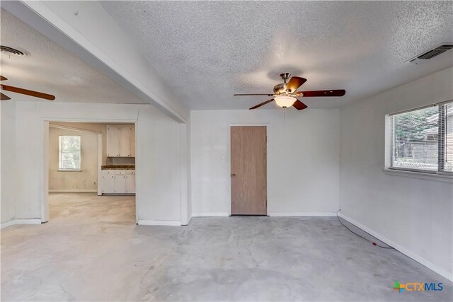 907 Curry Ave, Copperas Cove, TX 76522 - unfurnished room with a ceiling fan, a textured ceiling, concrete floors, and baseboards