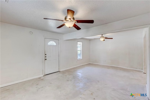 907 Curry Ave, Copperas Cove, TX 76522 - foyer featuring a textured ceiling, concrete flooring, a ceiling fan, and baseboards