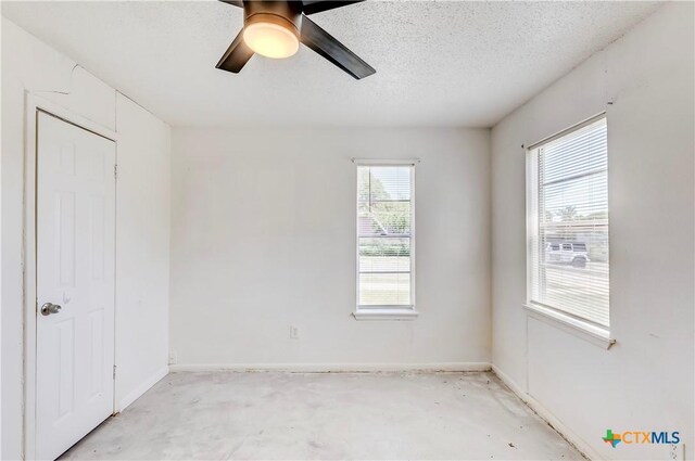 907 Curry Ave, Copperas Cove, TX 76522 - unfurnished bedroom with baseboards, ceiling fan, and a textured ceiling