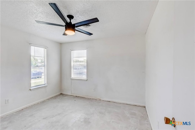 907 Curry Ave, Copperas Cove, TX 76522 - empty room with a textured ceiling, unfinished concrete flooring, a ceiling fan, and baseboards