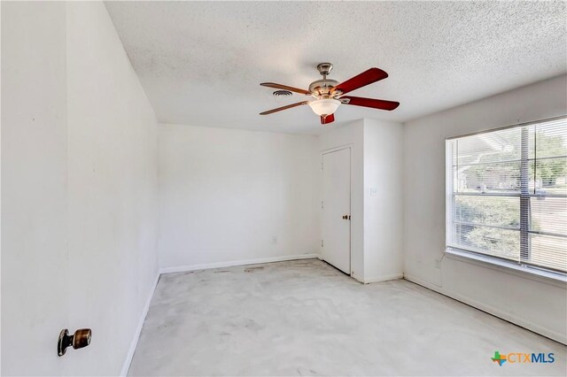 907 Curry Ave, Copperas Cove, TX 76522 - spare room with a textured ceiling, a ceiling fan, and baseboards