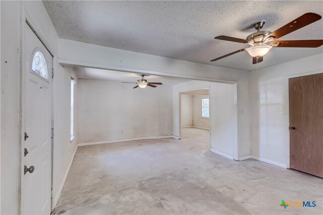 907 Curry Ave, Copperas Cove, TX 76522 - entrance foyer featuring unfinished concrete floors, ceiling fan, a textured ceiling, and baseboards