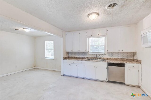 907 Curry Ave, Copperas Cove, TX 76522 - kitchen featuring dishwasher, a sink, white microwave, tasteful backsplash, and a textured ceiling