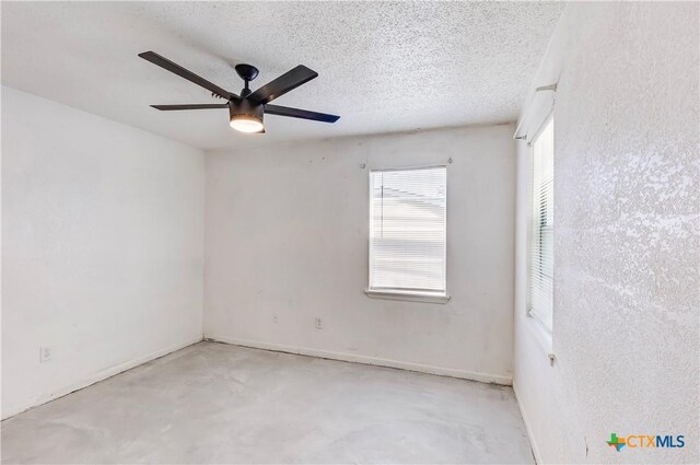 907 Curry Ave, Copperas Cove, TX 76522 - spare room featuring ceiling fan, concrete floors, and a textured ceiling