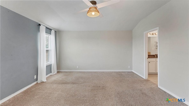 unfurnished room with light colored carpet, ceiling fan, and vaulted ceiling