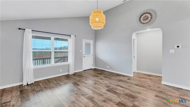 spare room with high vaulted ceiling and hardwood / wood-style flooring