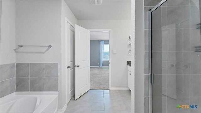 bathroom with shower with separate bathtub and tile patterned floors