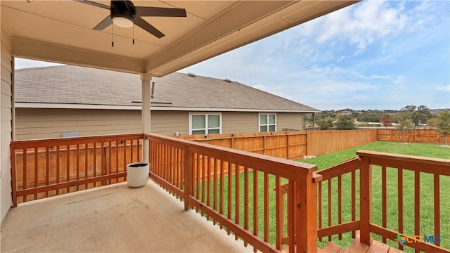 deck with ceiling fan and a yard